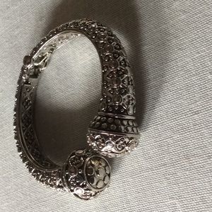 Silver tone bangle bracelet.